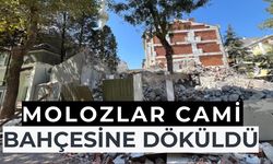 Yıkılan binanın molozları cami bahçesine döküldü